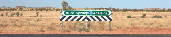 Alice Springs to Adelaide sign at the end of Ernest Giles Road on the Stuart Highway